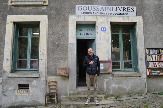 Nicolas Mahieu in front of his bookstore, Goussainlivres, in Goussainville, a ghost town that inspires the art of traveling (Photo © Meredith Mullins)