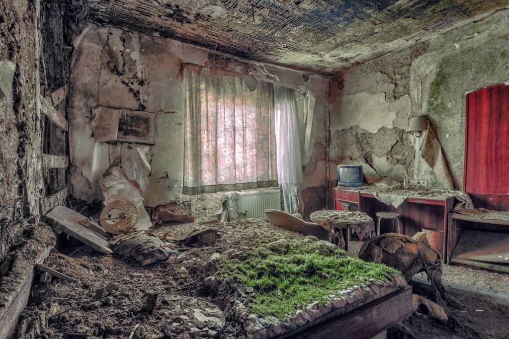 A deserted hotel room in Europe with plants growing over the bed, illustrating how photographers engaged in urban exploration make you see things differently. (image © Christian Richter).