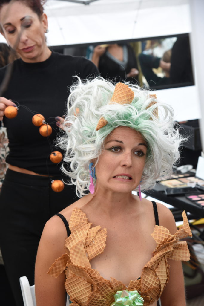 Erika Rosendale wears a waffle bodice and sits for her hairstylist at the 2018 Big Sur Fashion Show, a cultural encounter with the spirit of community. (Image © Meredith Mullins.)