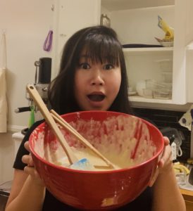 A young woman with a red bowl and chopsticks feels connected to the cultural traditions of her grandmother. (Image © Quinnie Lin)