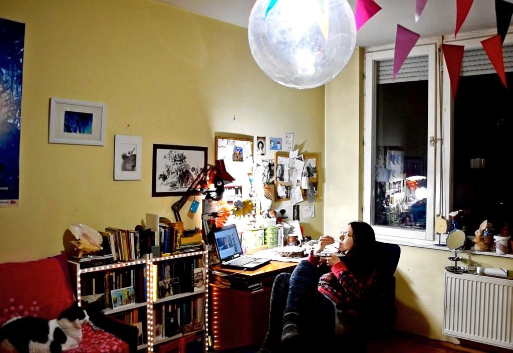 A woman eating cake alone during lockdown in Bulgaria due to a pandemic thinks about the cultural traditions that she usually associates with food. (Image © Hristina Bareva)